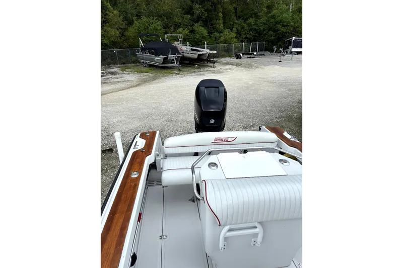 Slide: The Image of 1996 Boston Whaler 21 Outrage boat with outboard motor in a storage area. - 10