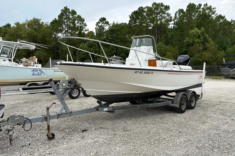 Slide: The Image of 1996 Boston Whaler 21 Outrage boat on trailer in outdoor setting. - 2