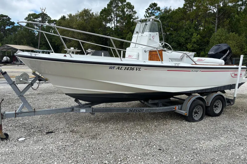 Slide: The Image of 1996 Boston Whaler 21 Outrage boat on trailer, parked outdoors. - 3