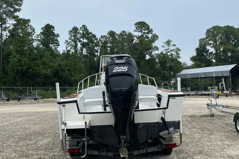 Slide: The Image of 1996 Boston Whaler 21 Outrage boat with 225 horsepower engine, parked outdoors. - 5