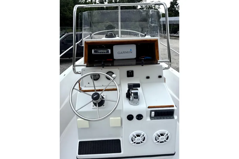Slide: The Image of 1996 Boston Whaler 21 Outrage boat console with steering wheel and Garmin navigation system. - 7