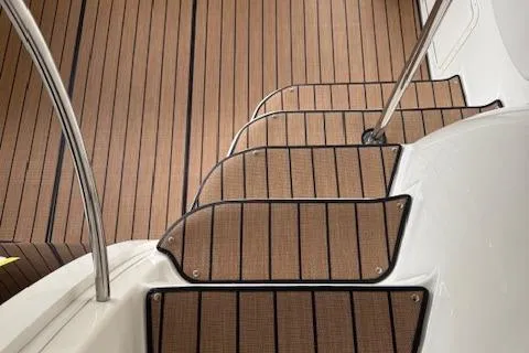 Slide: The Image of 2002 Regal Commodore 3880 boat steps with wood finish and metal railing. - 14