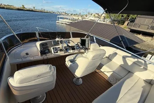 Slide: The Image of 2002 Regal Commodore 3880 yacht interior with helm, seating, and water view. - 16