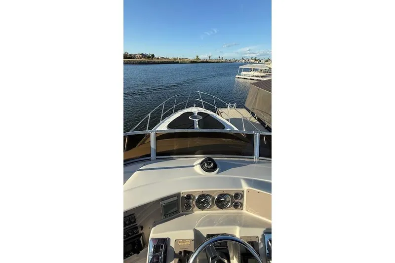 Slide: The Image of 2002 Regal Commodore 3880 yacht dashboard view on calm water. - 18