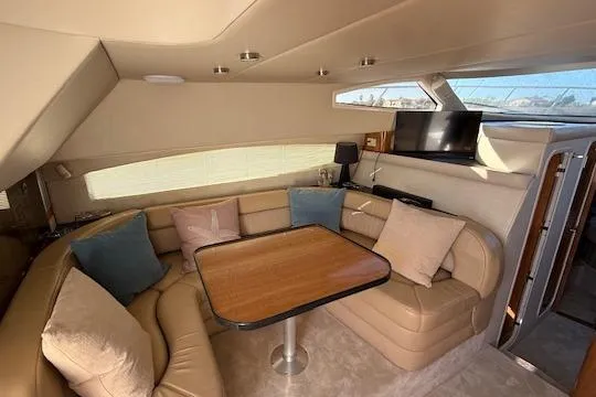 Slide: The Image of Luxurious interior of 2002 Regal Commodore 3880 yacht with cozy seating and table. - 23