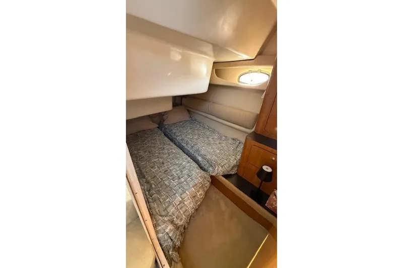 Slide: The Image of Cozy cabin interior of 2002 Regal Commodore 3880 with twin beds and wooden cabinetry. - 33