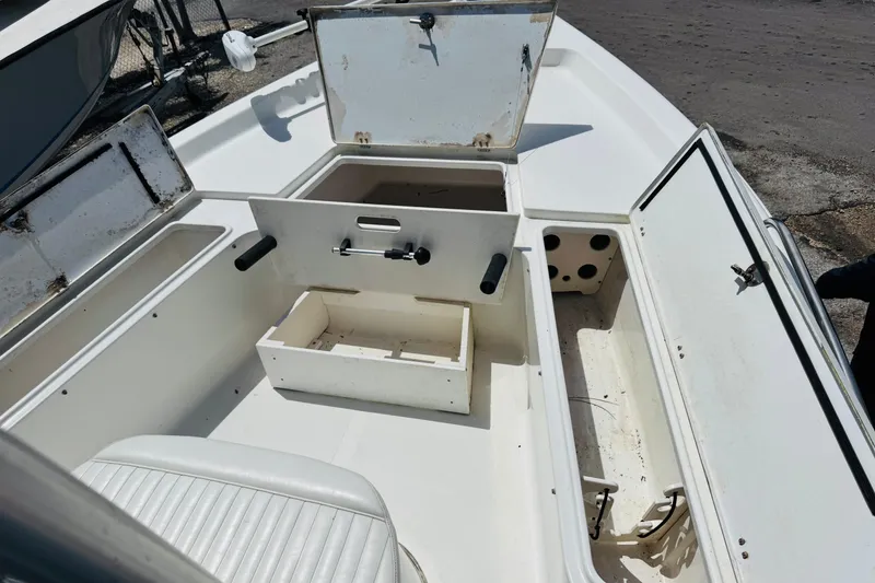 Slide: The Image of 2006 Sea Pro SV2100 CC boat interior with open storage compartments and seating. - 8