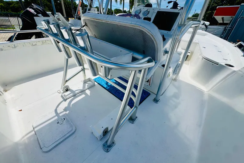 Slide: The Image of 2006 Sea Pro SV2100 CC boat interior with rod holders and console. - 9