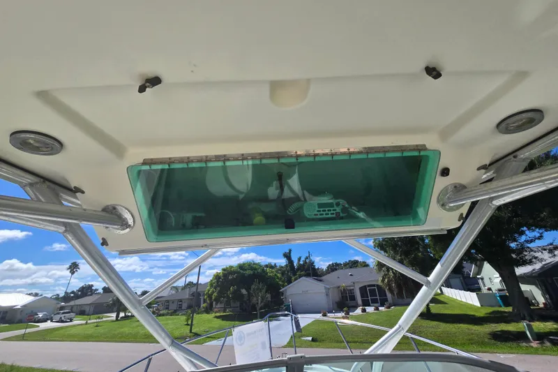 Slide: The Image of 2005 Trophy 2352 Walkaround boat interior view with overhead storage and radio equipment. - 12