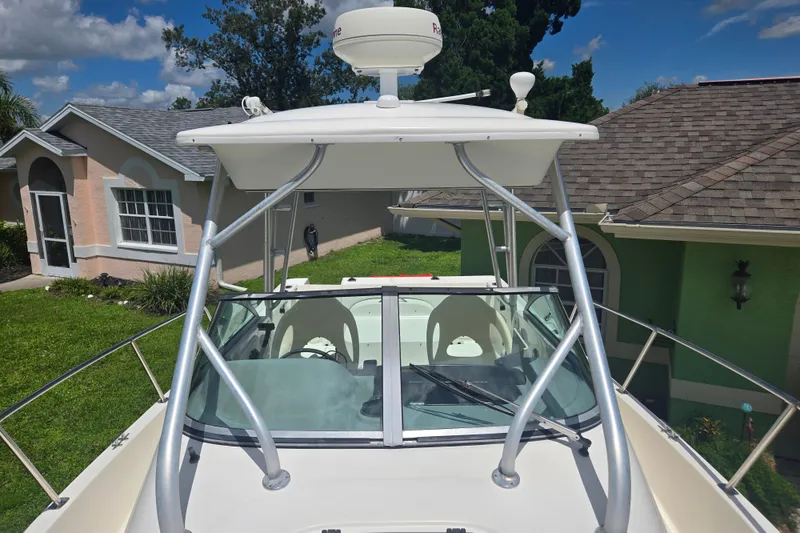 Slide: The Image of 2005 Trophy Sportfishing boat with radar, parked near residential homes. - 16