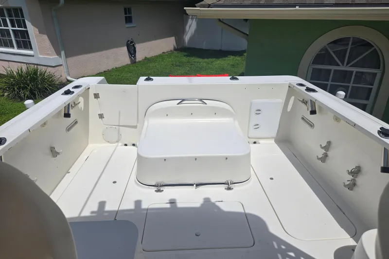 Slide: The Image of 2005 Trophy Sportfishing boat deck with seating and rod holders, in a residential backyard. - 17