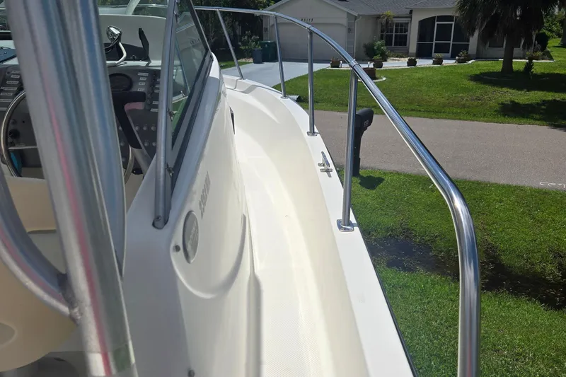 Slide: The Image of 2005 Trophy Sportfishing boat deck with railing, parked in a residential area. - 20