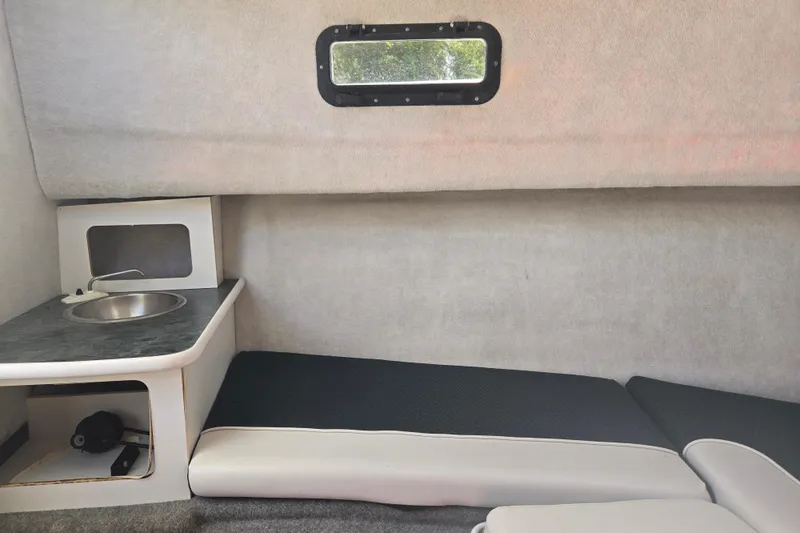 Slide: The Image of Interior of a 2005 Trophy Sportfishing boat with a compact sink and seating area. - 27