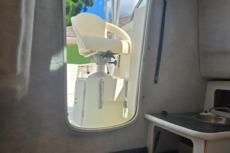 Slide: The Image of 2005 Trophy Sportfishing boat interior with captain's chair and compact kitchenette. - 29