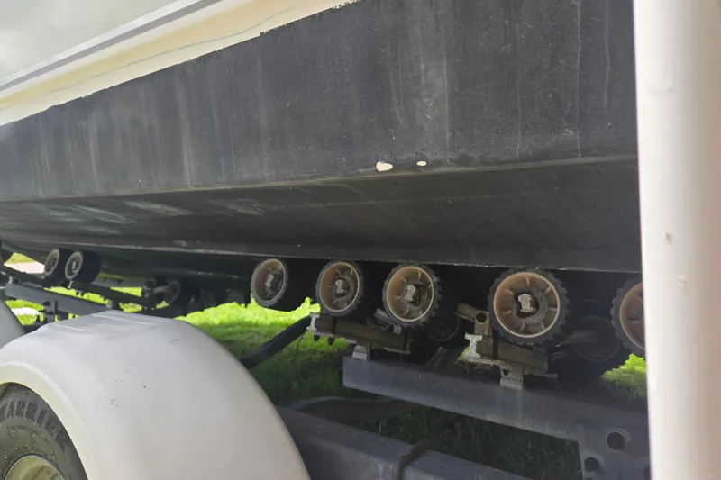 Slide: The Image of 2005 Trophy Sportfishing boat on trailer rollers, close-up view. - 36