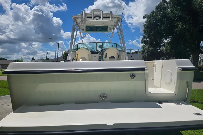 Slide: The Image of 2005 Trophy Sportfishing boat, rear view, under a partly cloudy sky. - 4