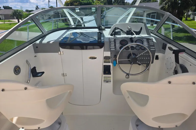 Slide: The Image of 2005 Trophy Sportfishing boat cockpit with steering wheel and control panel. - 9