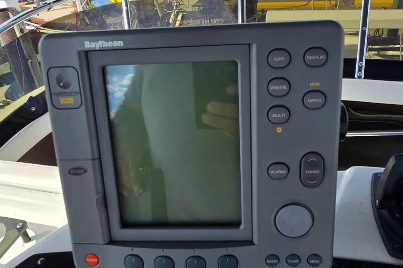 Slide: The Image of Raytheon chartplotter on 1987 Trojan 10.8 Meter Sedan boat dashboard. - 23
