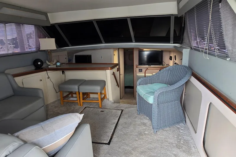 Slide: The Image of Interior of a 1987 Trojan 10.8 Meter Sedan yacht with cozy seating and modern amenities. - 26