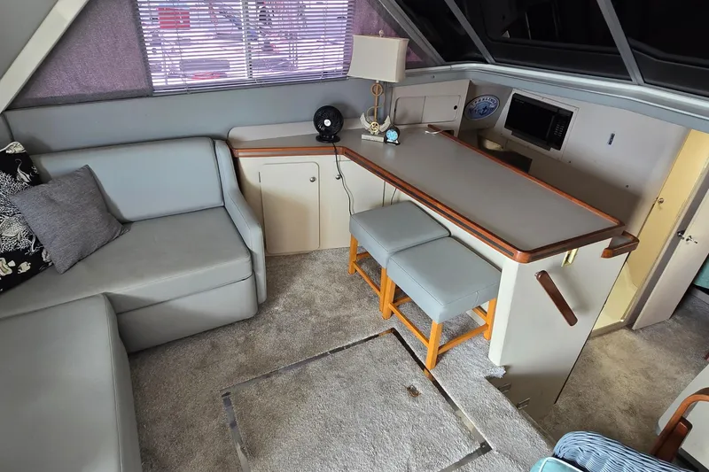 Slide: The Image of Interior of 1987 Trojan 10.8 Meter Sedan with seating, table, and decor. - 27