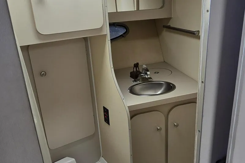 Slide: The Image of 1987 Trojan 10.8 Meter Sedan bathroom with sink, storage, and compact design. - 35