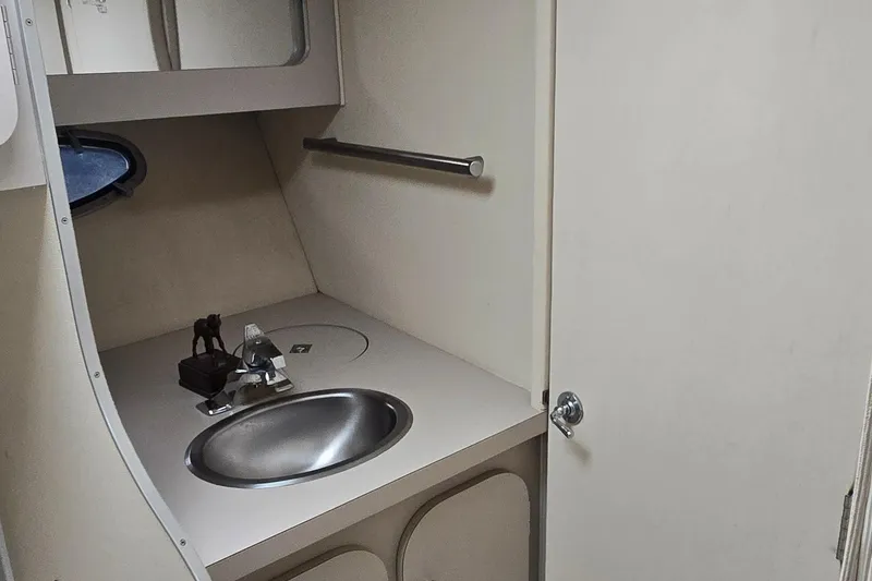 Slide: The Image of 1987 Trojan 10.8 Meter Sedan bathroom with sink and mirror. - 36