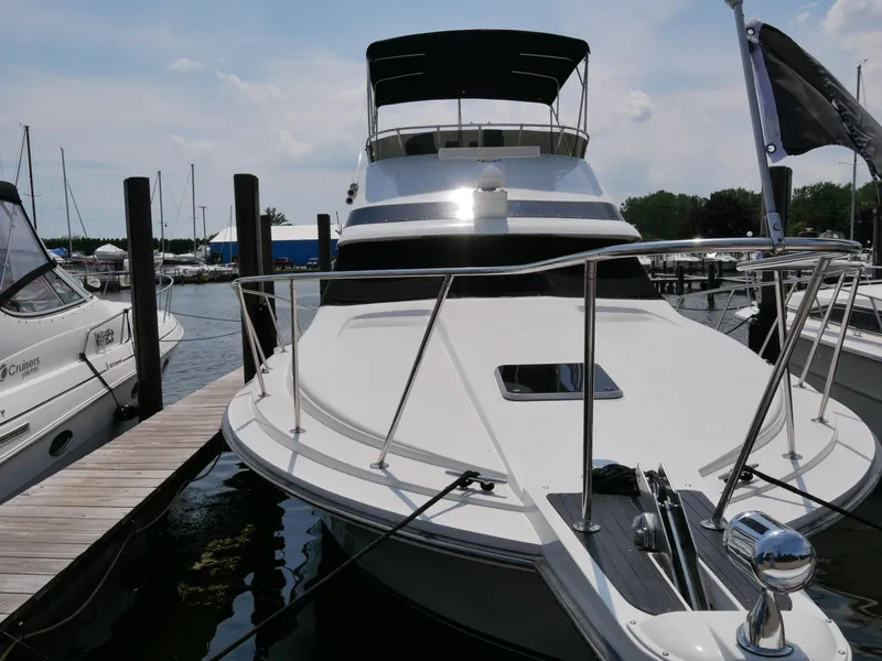 Slide: The Image of 1987 Trojan 10.8 Meter Sedan yacht docked at a marina. - 4