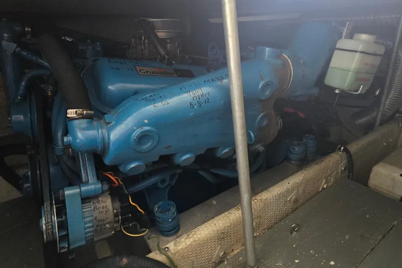 Slide: The Image of Engine compartment of a 1987 Trojan 10.8 Meter Sedan boat, featuring a Crusader engine. - 43