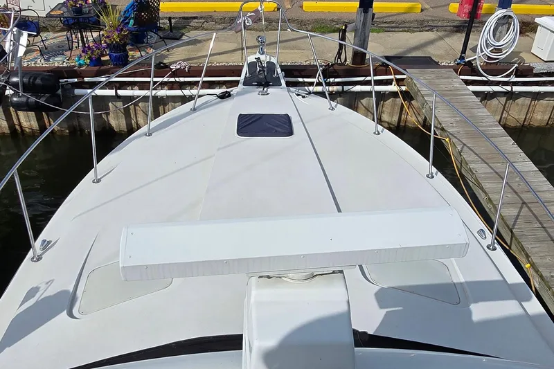 Slide: The Image of 1987 Trojan 10.8 Meter Sedan boat docked at marina, view from bow. - 7