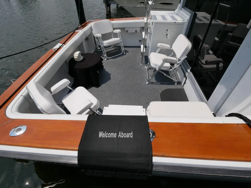 Slide: The Image of 1987 Trojan 10.8 Meter Sedan boat with seating area and Welcome Aboard sign. - 10