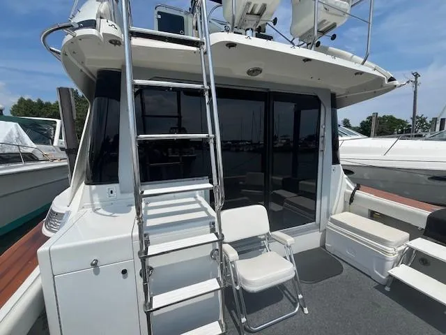 Slide: The Image of 1987 Trojan 10.8 Meter Sedan boat with ladder and seating on deck. - 11