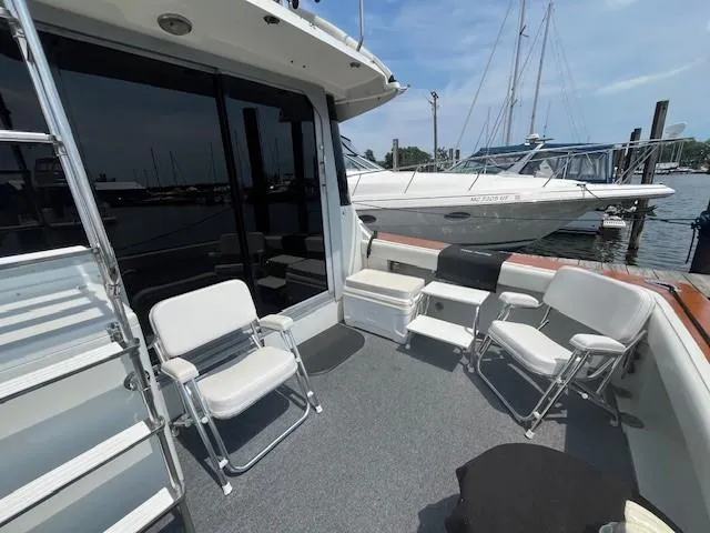 Slide: The Image of 1987 Trojan 10.8 Meter Sedan boat deck with chairs at marina. - 12