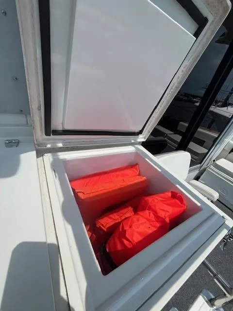 Slide: The Image of Storage compartment on a 1987 Trojan 10.8 Meter Sedan boat with life jackets. - 14