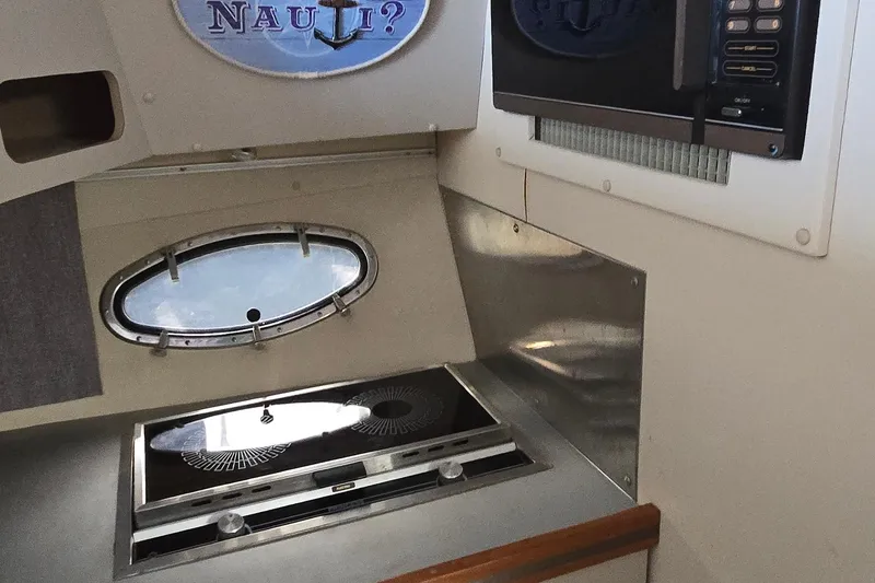 Slide: The Image of 1987 Trojan 10.8 Meter Sedan interior kitchen with stove and microwave. - 31