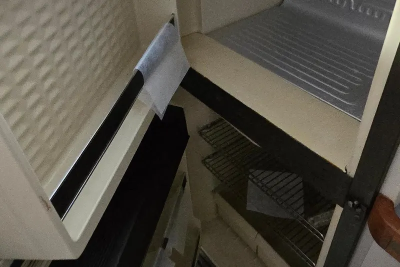 Slide: The Image of Interior view of a 1987 Trojan 10.8 Meter Sedan boat, featuring storage compartments. - 34