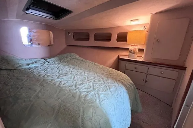 Slide: The Image of 1987 Trojan 10.8 Meter Sedan cabin with bed, lamp, and storage cabinets. - 40