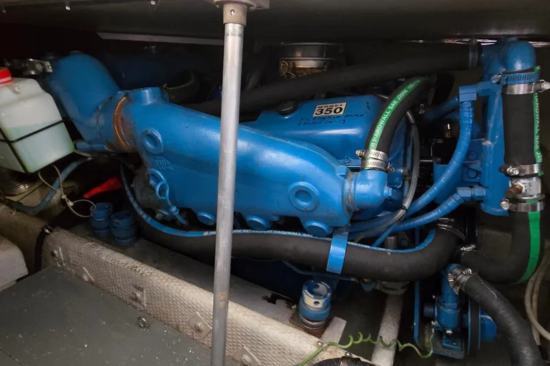 Slide: The Image of 1987 Trojan 10.8 Meter Sedan engine compartment with blue marine engine components. - 42