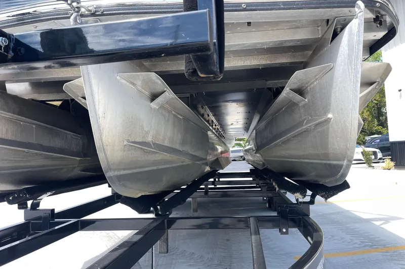 Slide: The Image of Underneath view of a 2020 Crest 250 Caribbean pontoon boat on a trailer. - 11