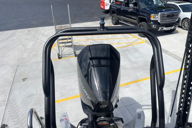 Slide: The Image of 2020 Crest 250 Caribbean boat with outboard motor in a parking lot. - 13