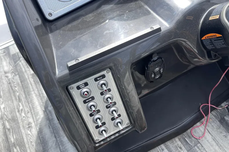 Slide: The Image of Control panel of 2020 Crest 250 Caribbean boat with switches and warning label. - 20