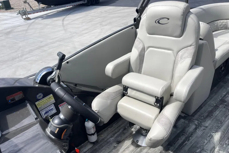 Slide: The Image of Captain's seat and helm of 2020 Crest 250 Caribbean boat, featuring modern controls. - 21