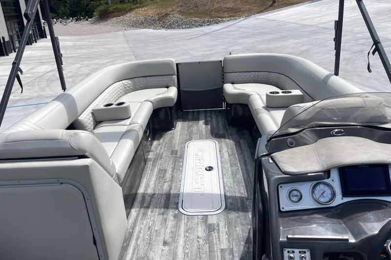Slide: The Image of Interior of a 2020 Crest 250 Caribbean boat with luxurious seating and modern dashboard. - 23
