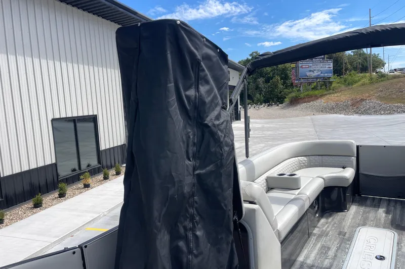 Slide: The Image of 2020 Crest 250 Caribbean pontoon boat with covered seating area, parked outdoors. - 24