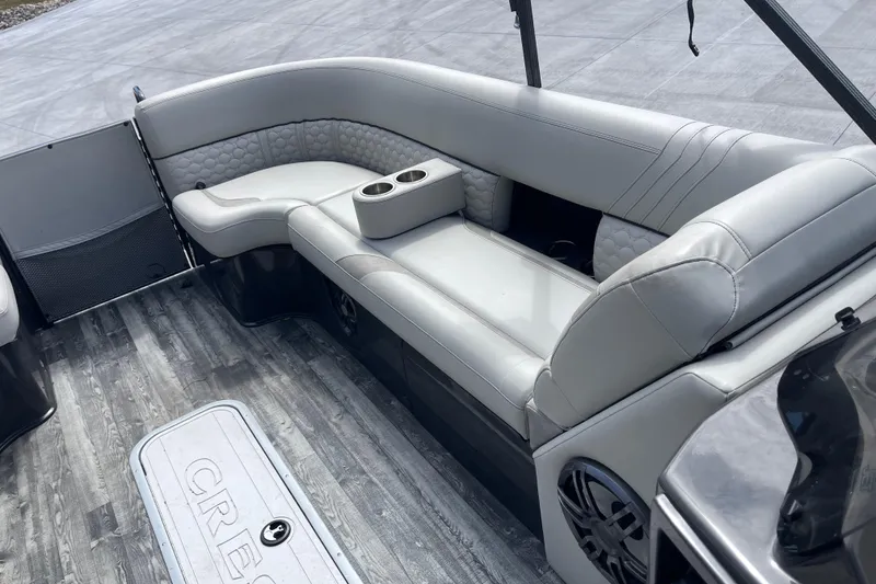 Slide: The Image of 2020 Crest 250 Caribbean boat interior with gray seating and cup holders. - 25