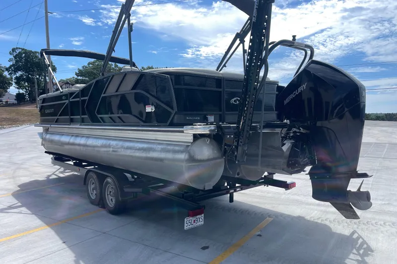 Slide: The Image of 2020 Crest 250 Caribbean pontoon boat on trailer, featuring a Mercury outboard motor. - 6