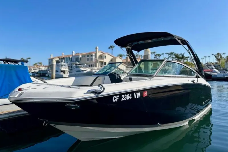 The Image of 2016 Regal 23 OBX boat docked in a sunny marina setting. - 0