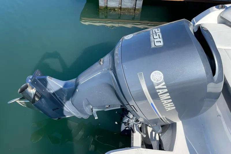 Slide: The Image of Yamaha 250 outboard motor on 2016 Regal 23 OBX boat, docked in clear water. - 10