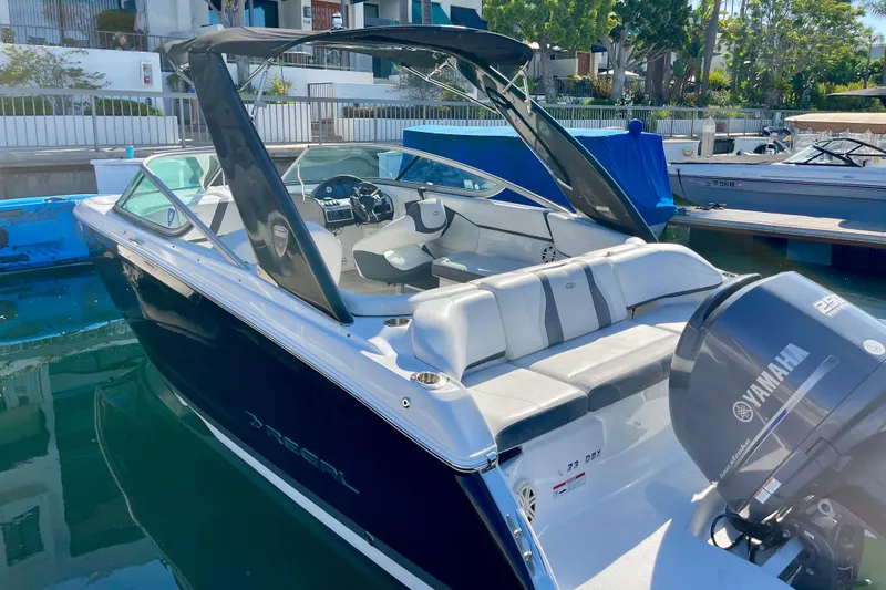 Slide: The Image of 2016 Regal 23 OBX boat with Yamaha outboard motor docked in marina. - 12