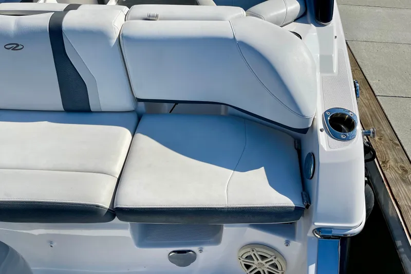 Slide: The Image of 2016 Regal 23 OBX boat seating area with cup holder and speaker. - 14