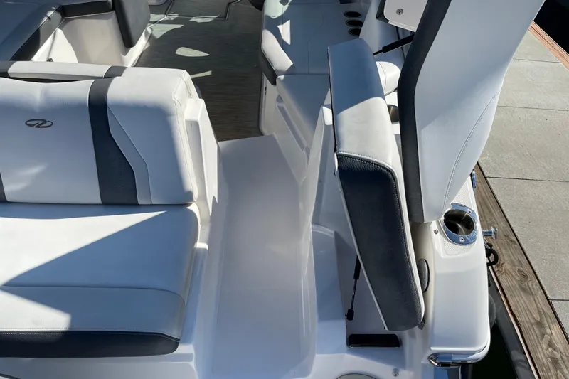 Slide: The Image of Interior seating of a 2016 Regal 23 OBX boat, featuring white and black upholstery. - 15